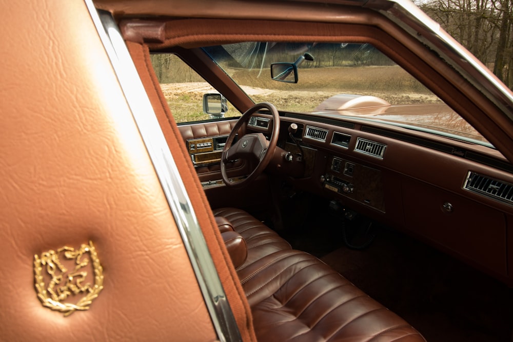 the interior of a car with a brown leather seat