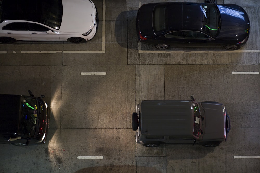 three cars parked in a parking lot next to each other