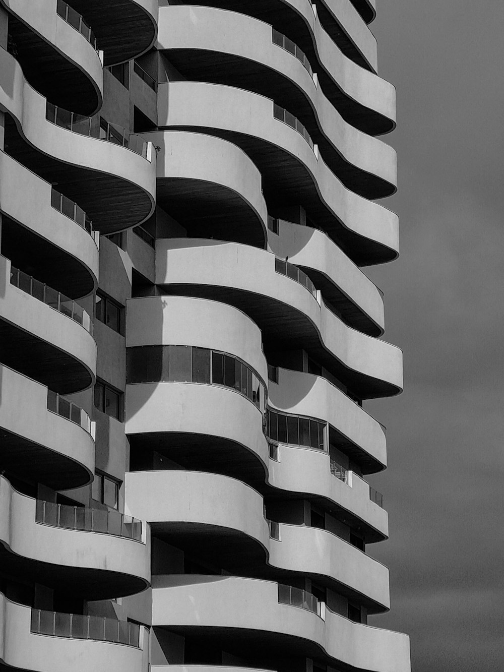 a black and white photo of a building with balconies