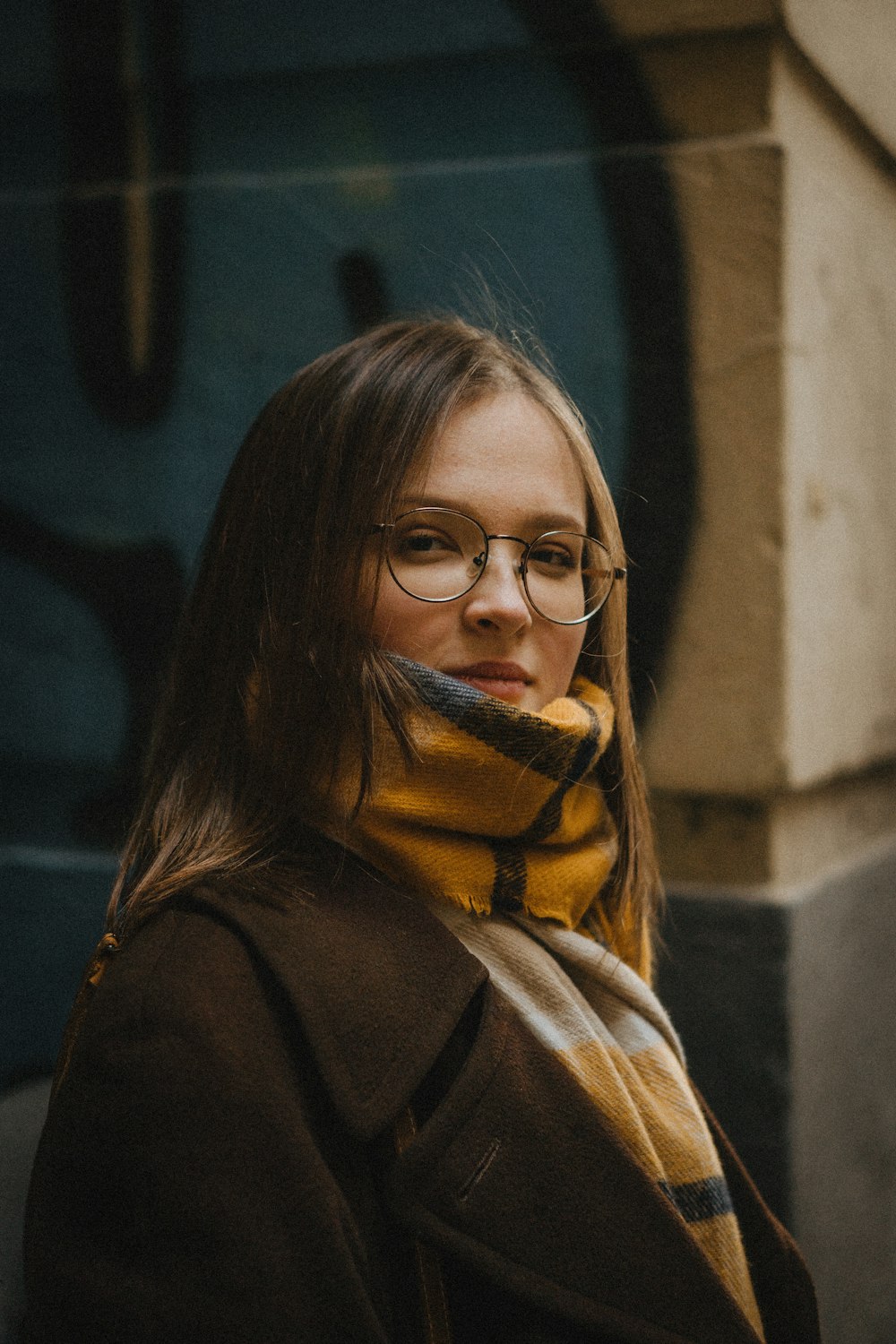 a woman wearing glasses and a scarf