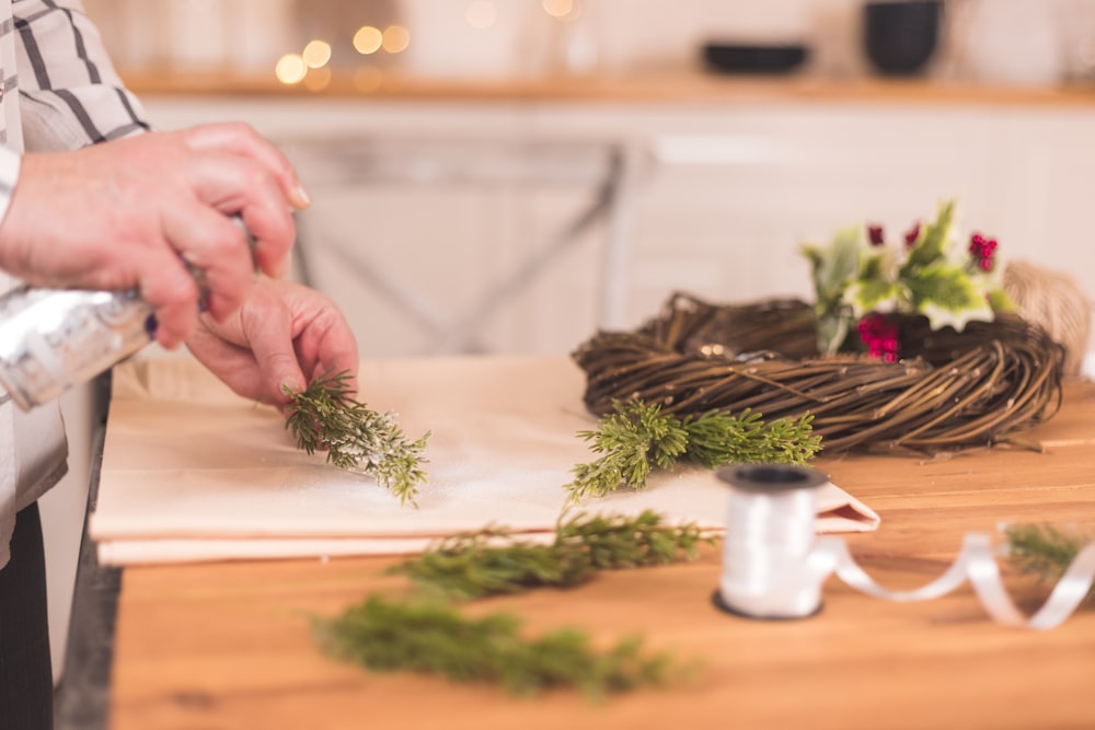 a person is making a wreath out of twigs