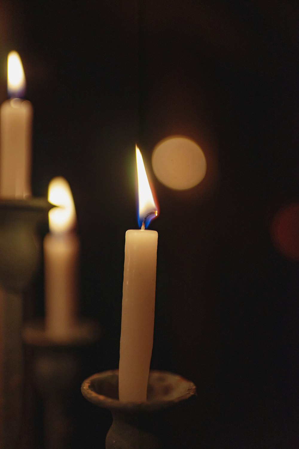 a group of lit candles sitting on top of a table