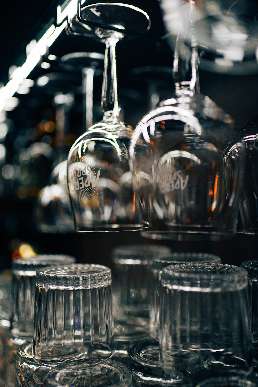 a row of wine glasses sitting on top of a shelf