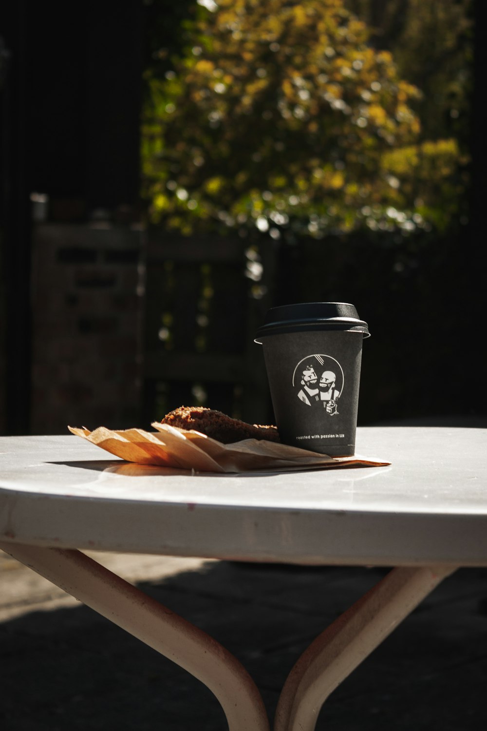 a cup of coffee sitting on top of a white table