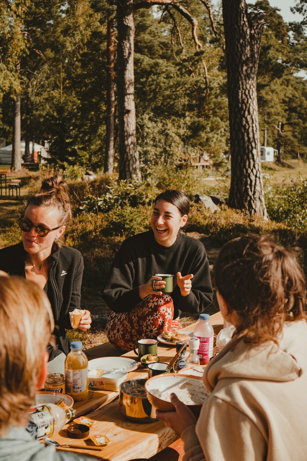 a group of people sitting around a table eating food