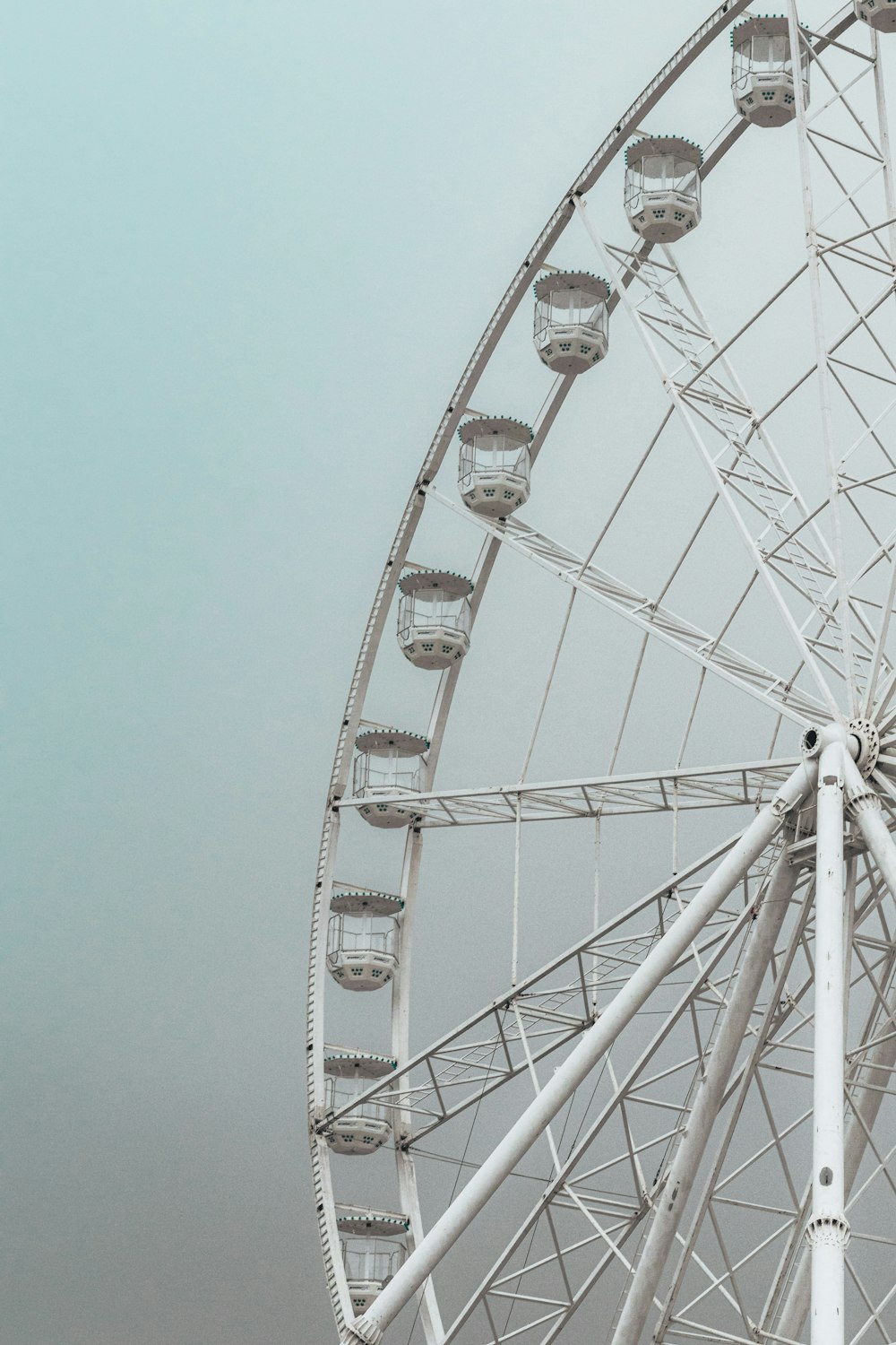a ferris wheel in the middle of a cloudy sky
