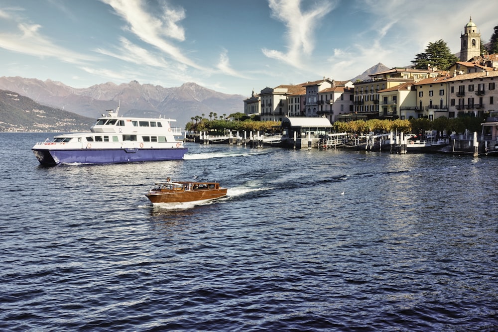 a boat traveling down a river next to a town