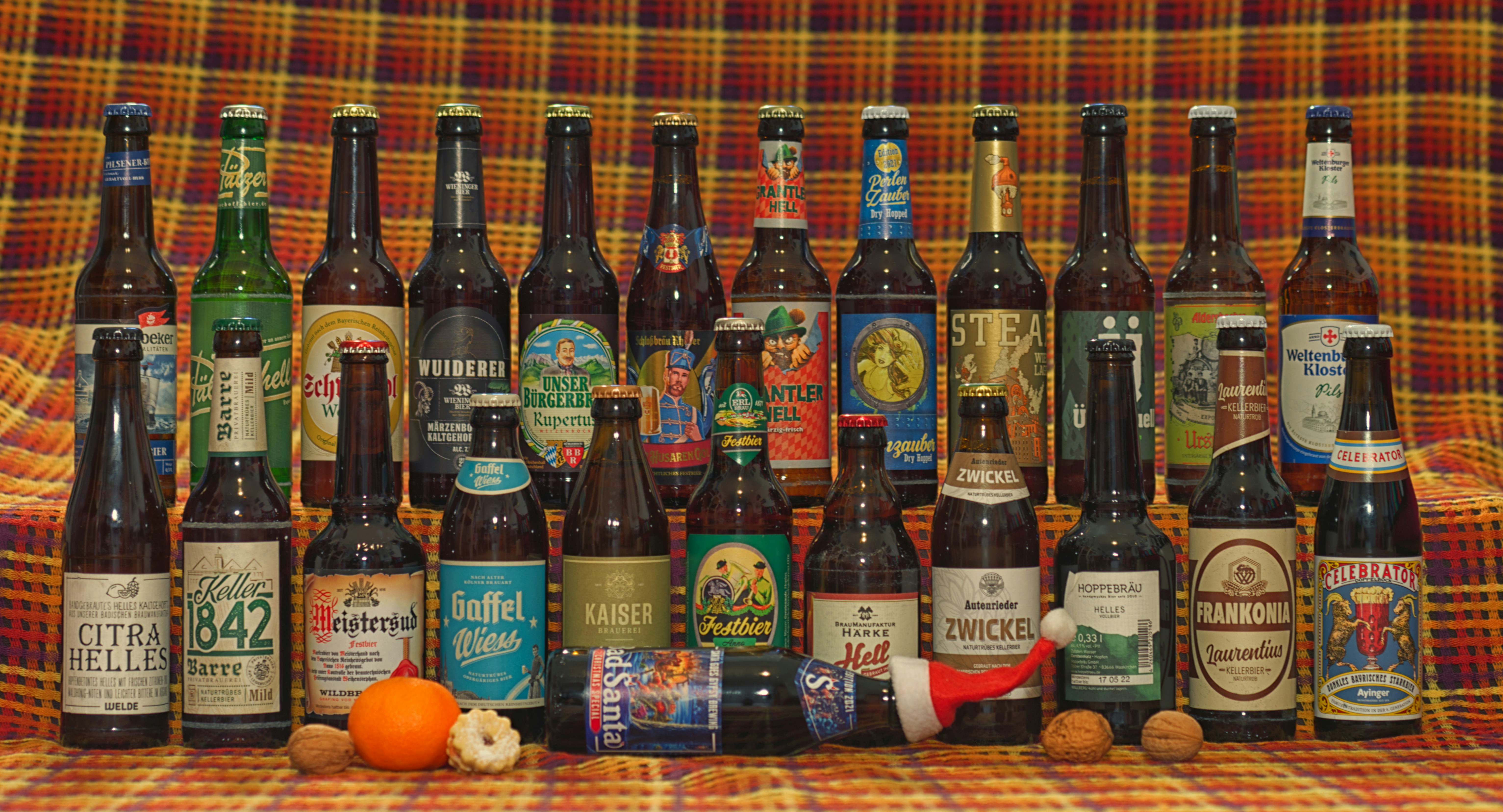 A collection of beer bottles sitting on top of a couch photo Free