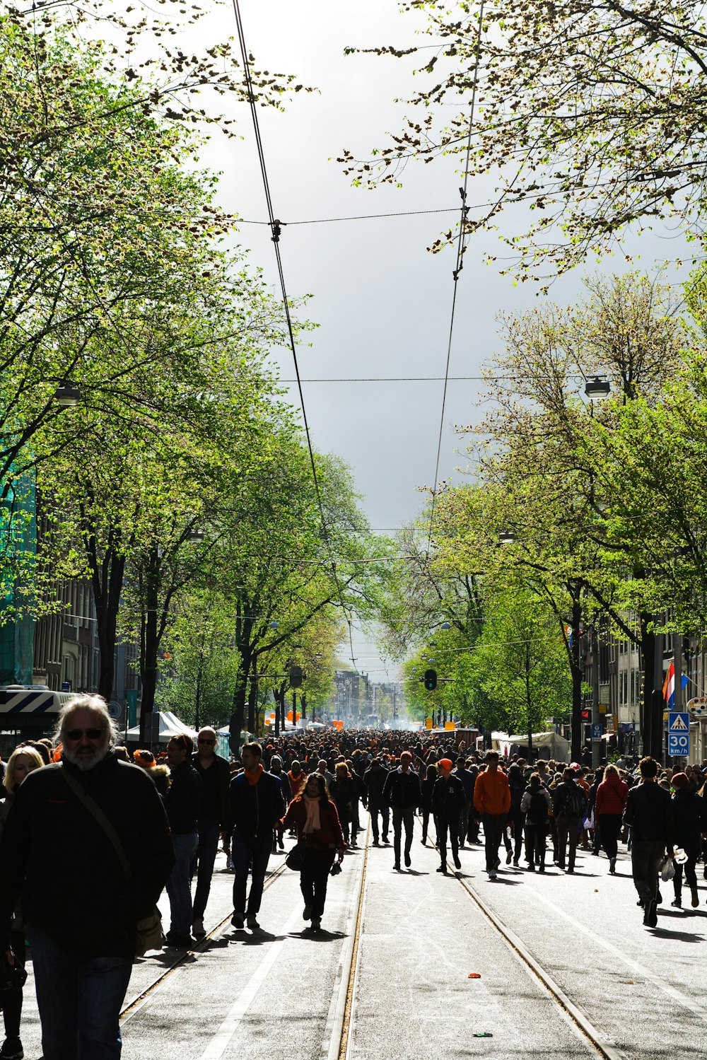 a crowd of people walking down a street