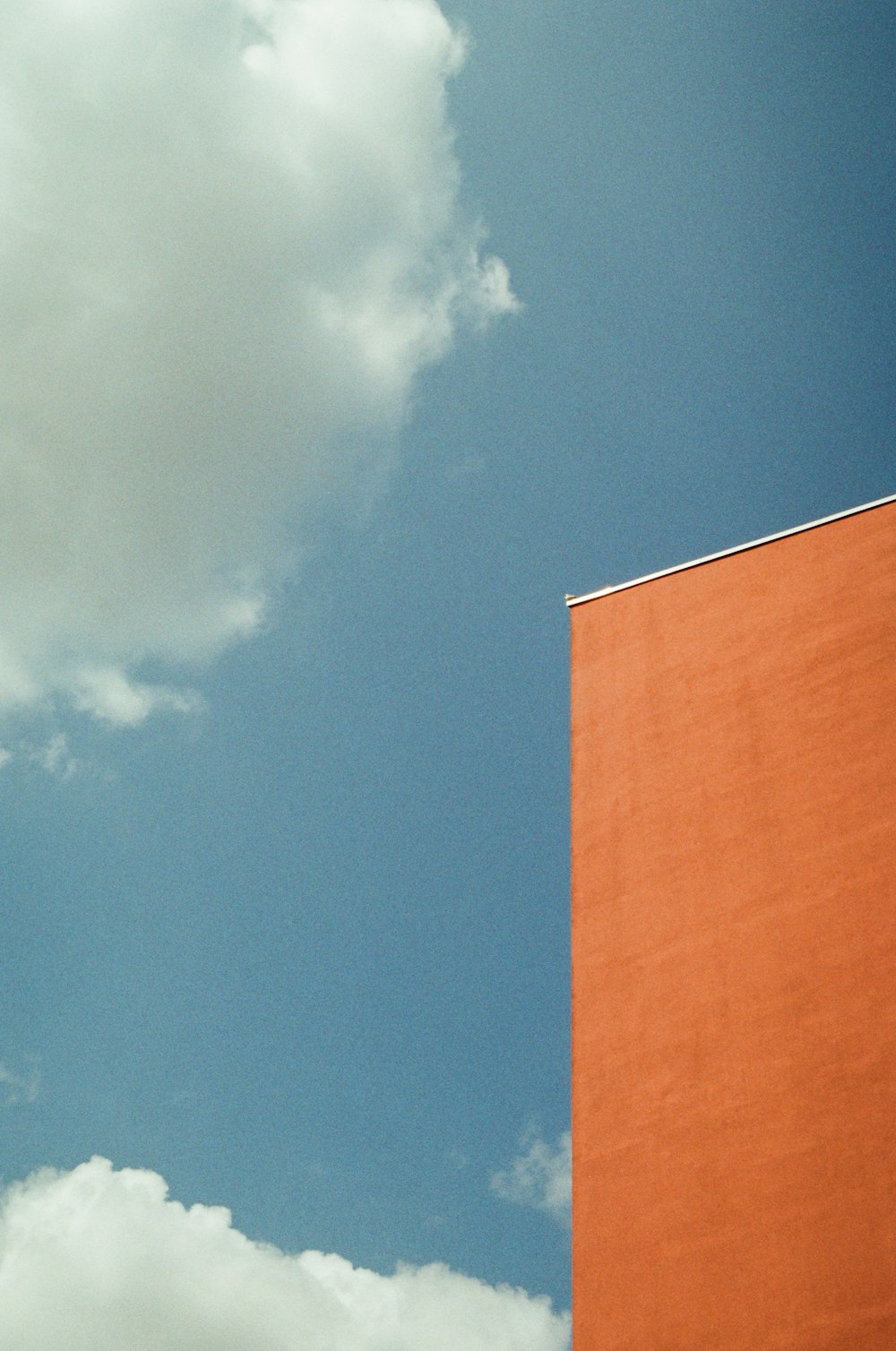 a red building with a clock on the side of it