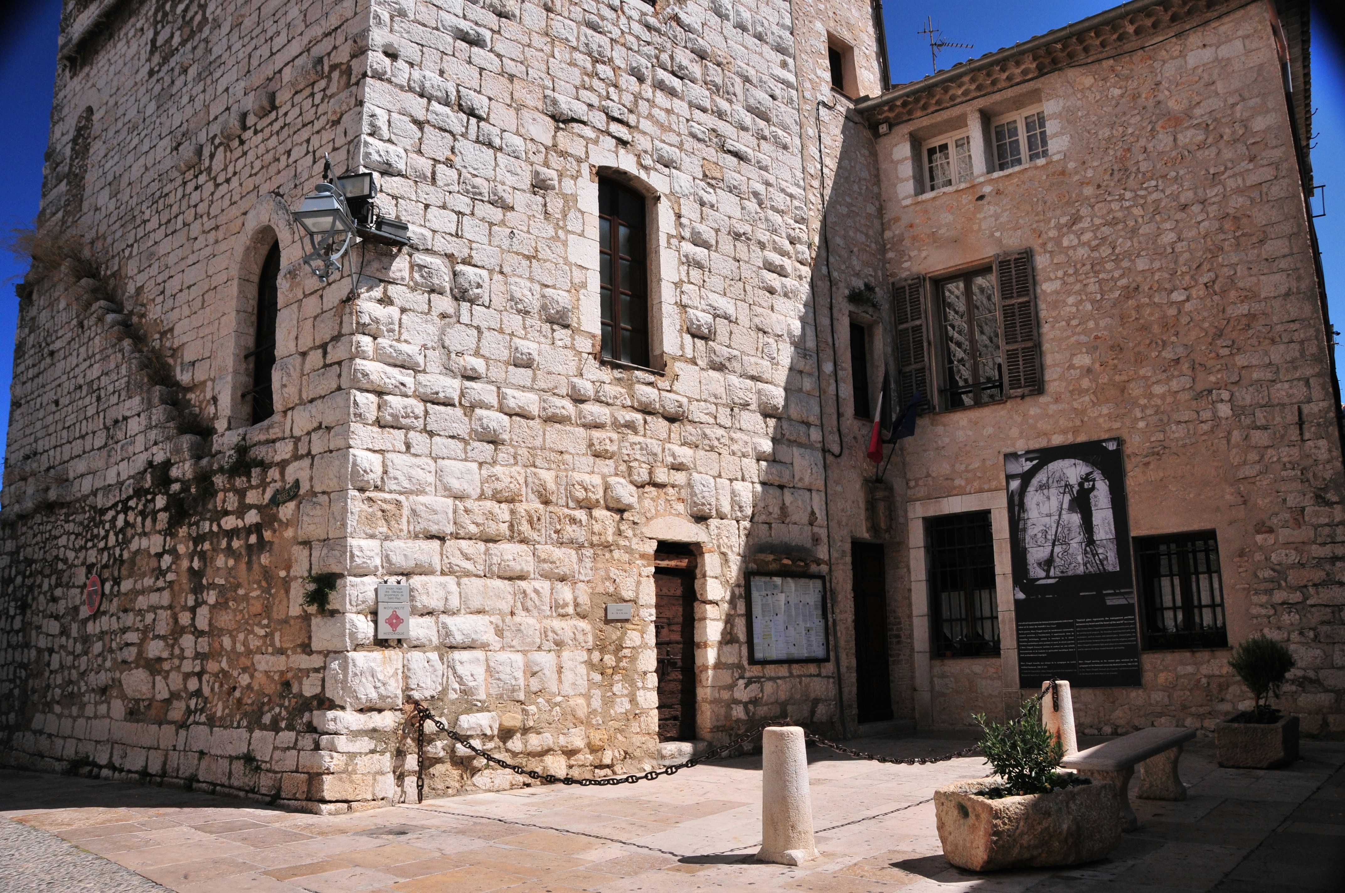 a stone building with a clock on the side of it