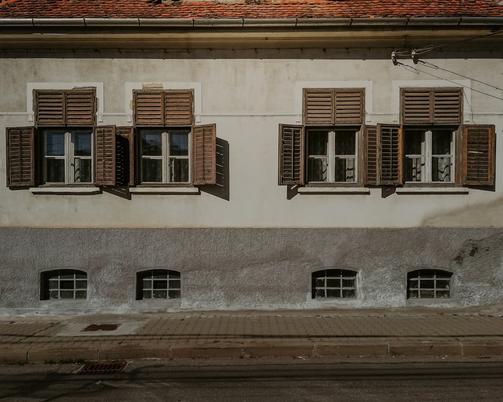 a building with windows and shutters on the side of it
