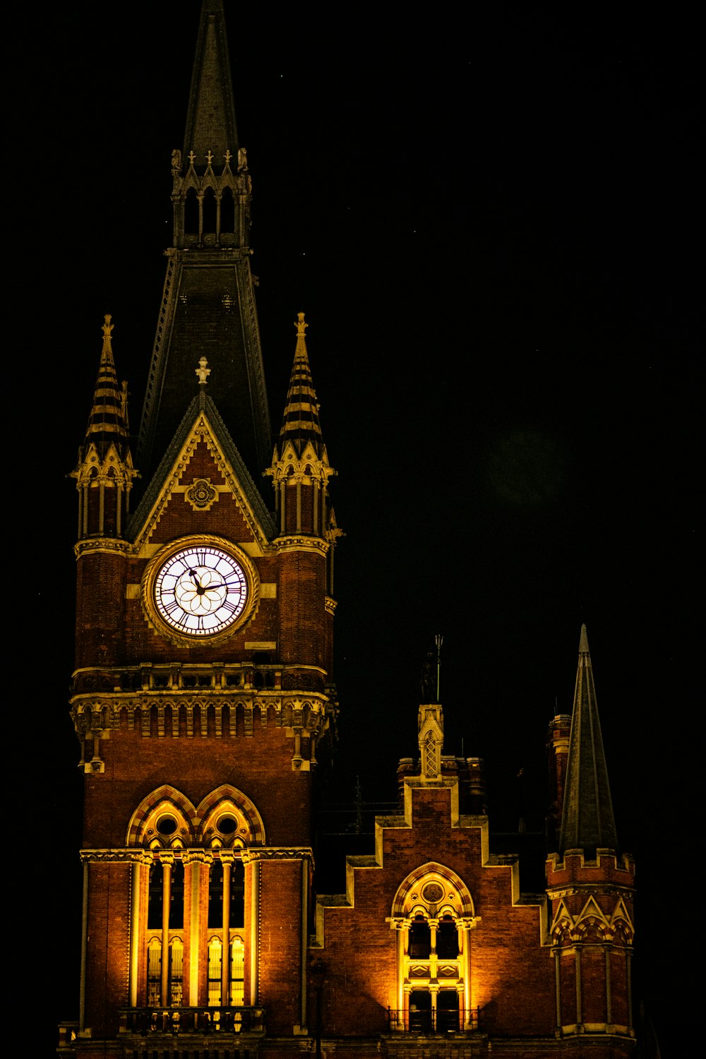 a large clock tower lit up at night