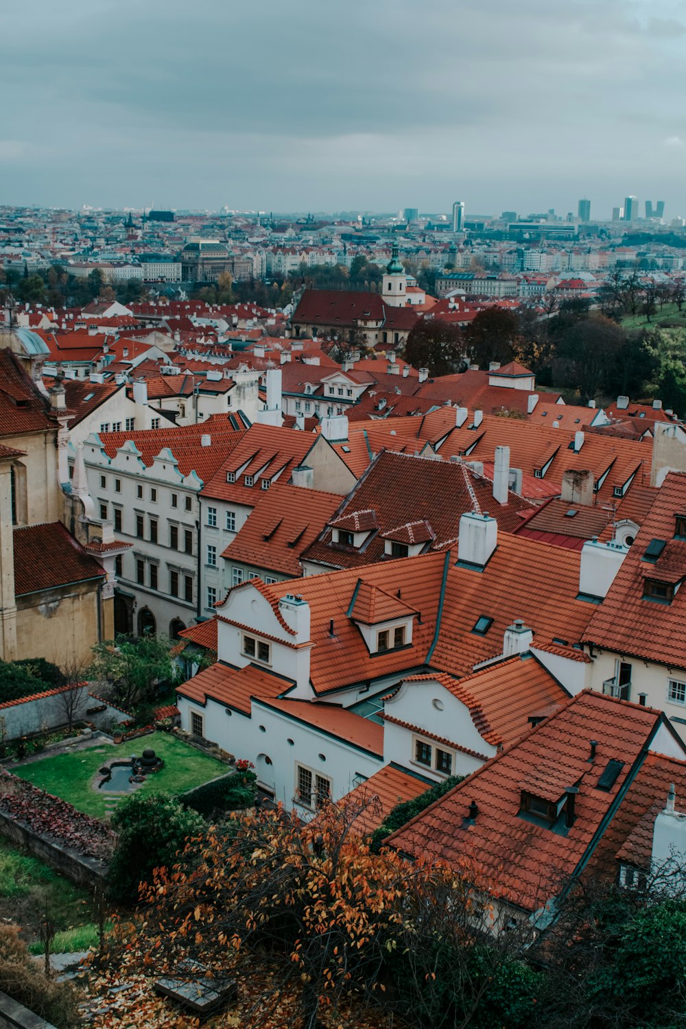 an aerial view of a city with red roofs