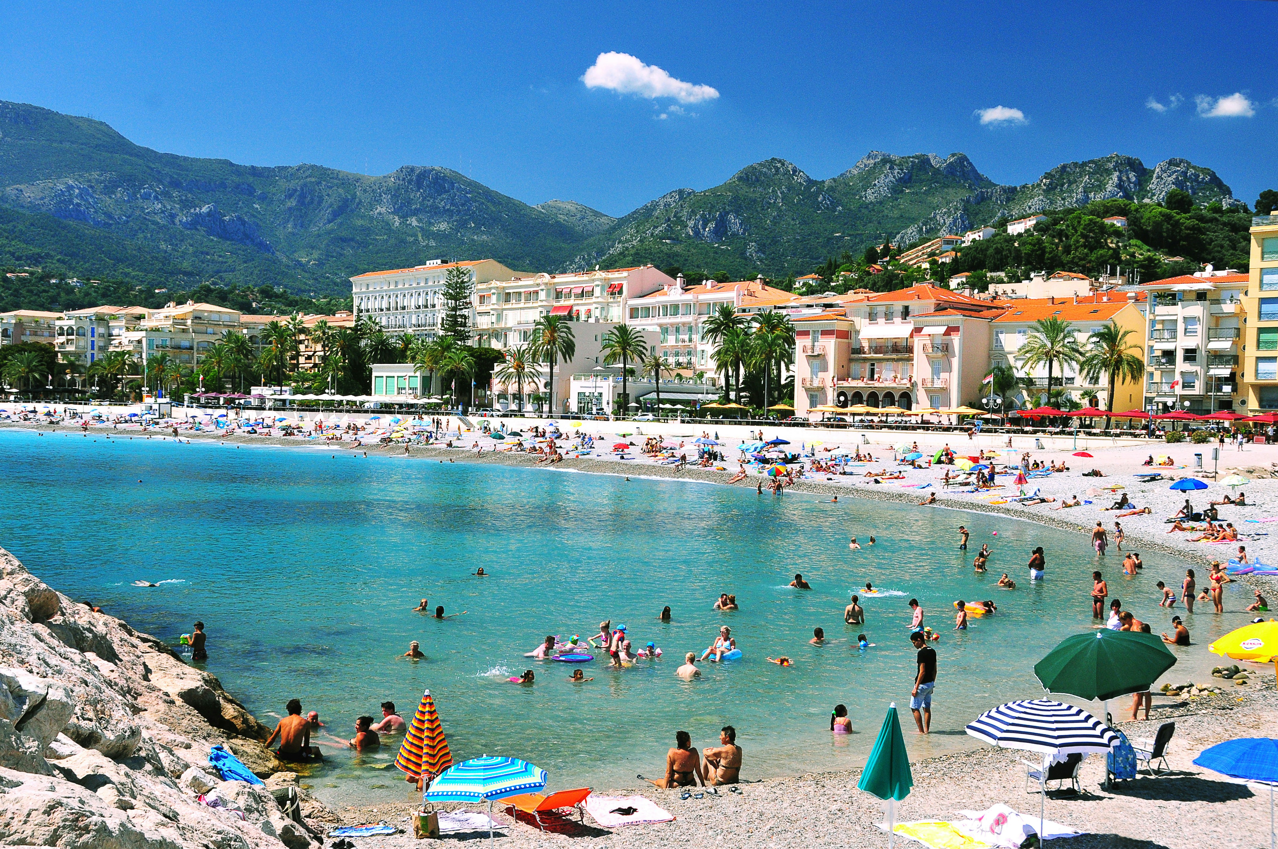 many people are on the beach and in the water