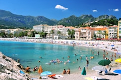 many people are on the beach and in the water