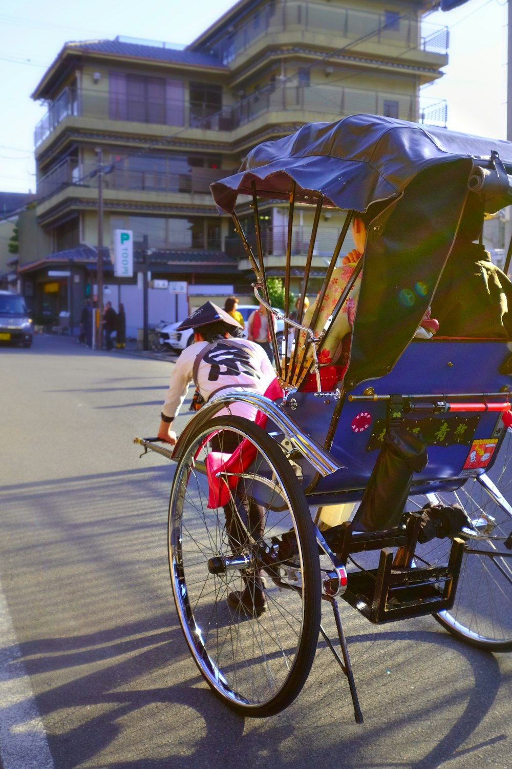 a person riding a bike with a cart attached to it