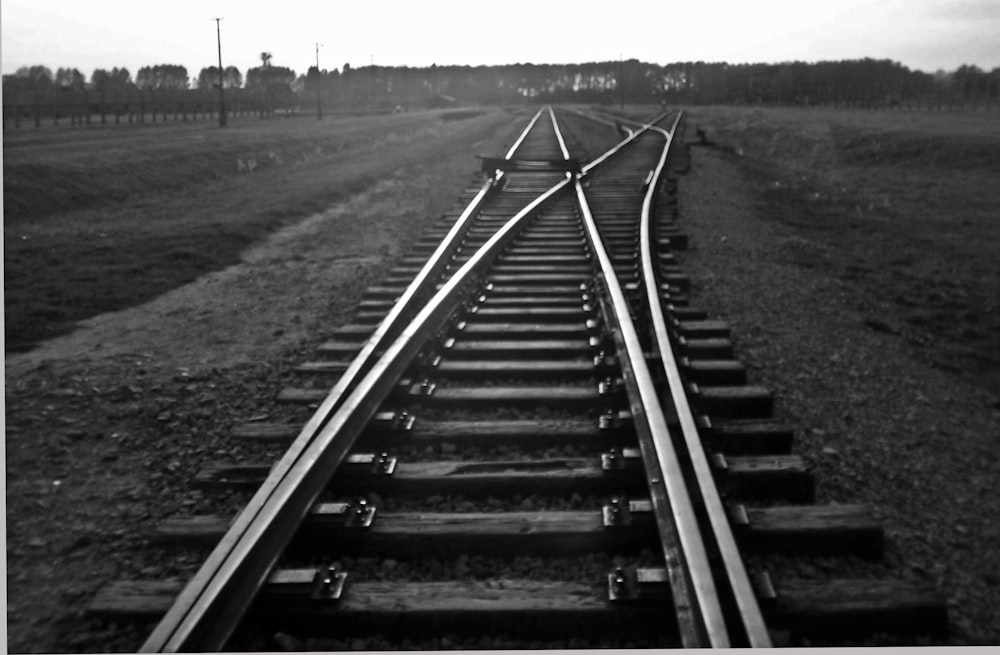 a black and white photo of a train track