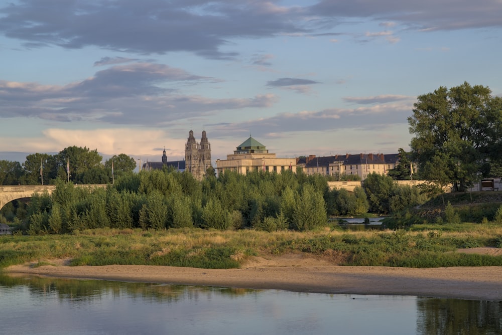 a large building sitting on top of a hill next to a river