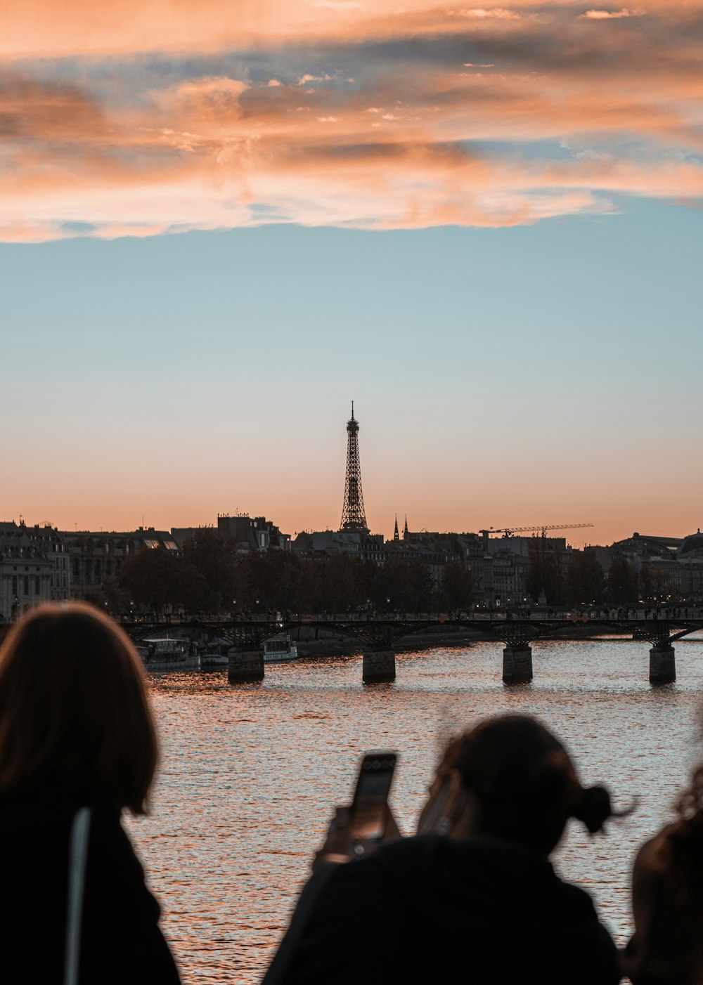 a group of people standing next to each other near a river