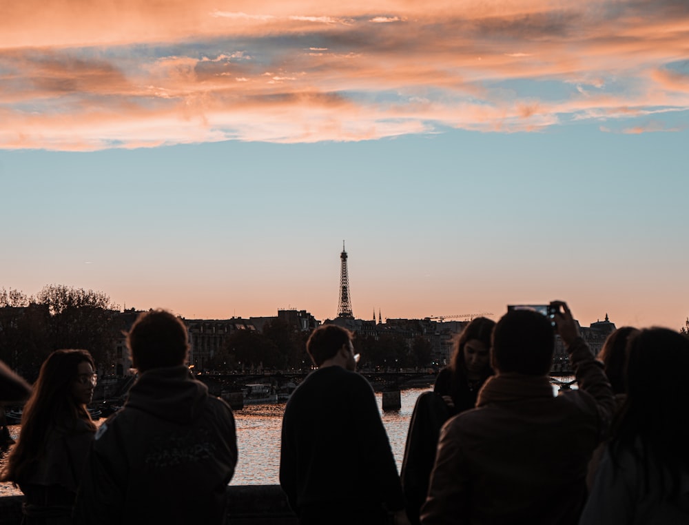 a group of people looking at the eiffel tower