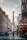 A bustling street in Paris with cafes and people.