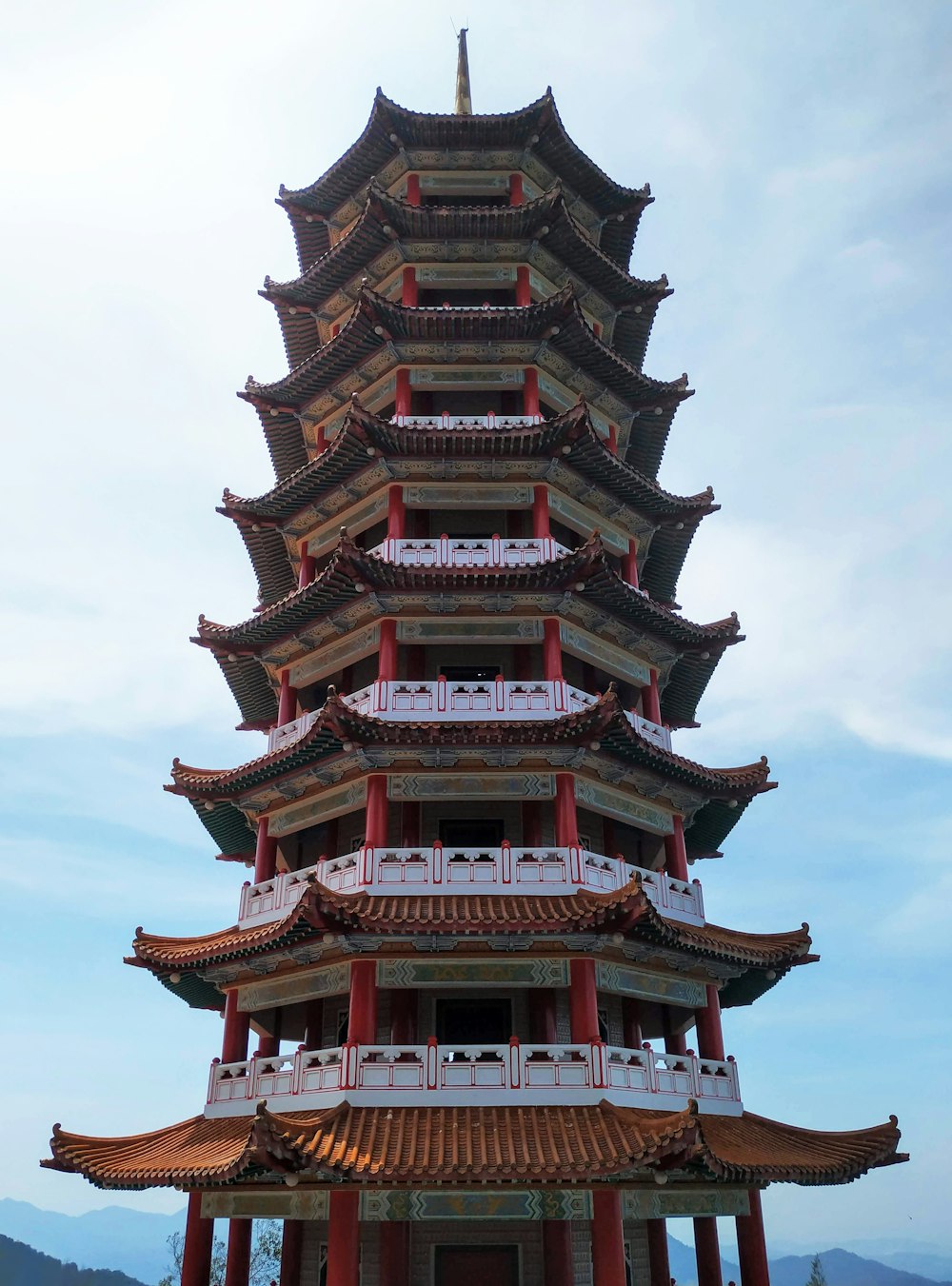 a tall building with a red and white roof