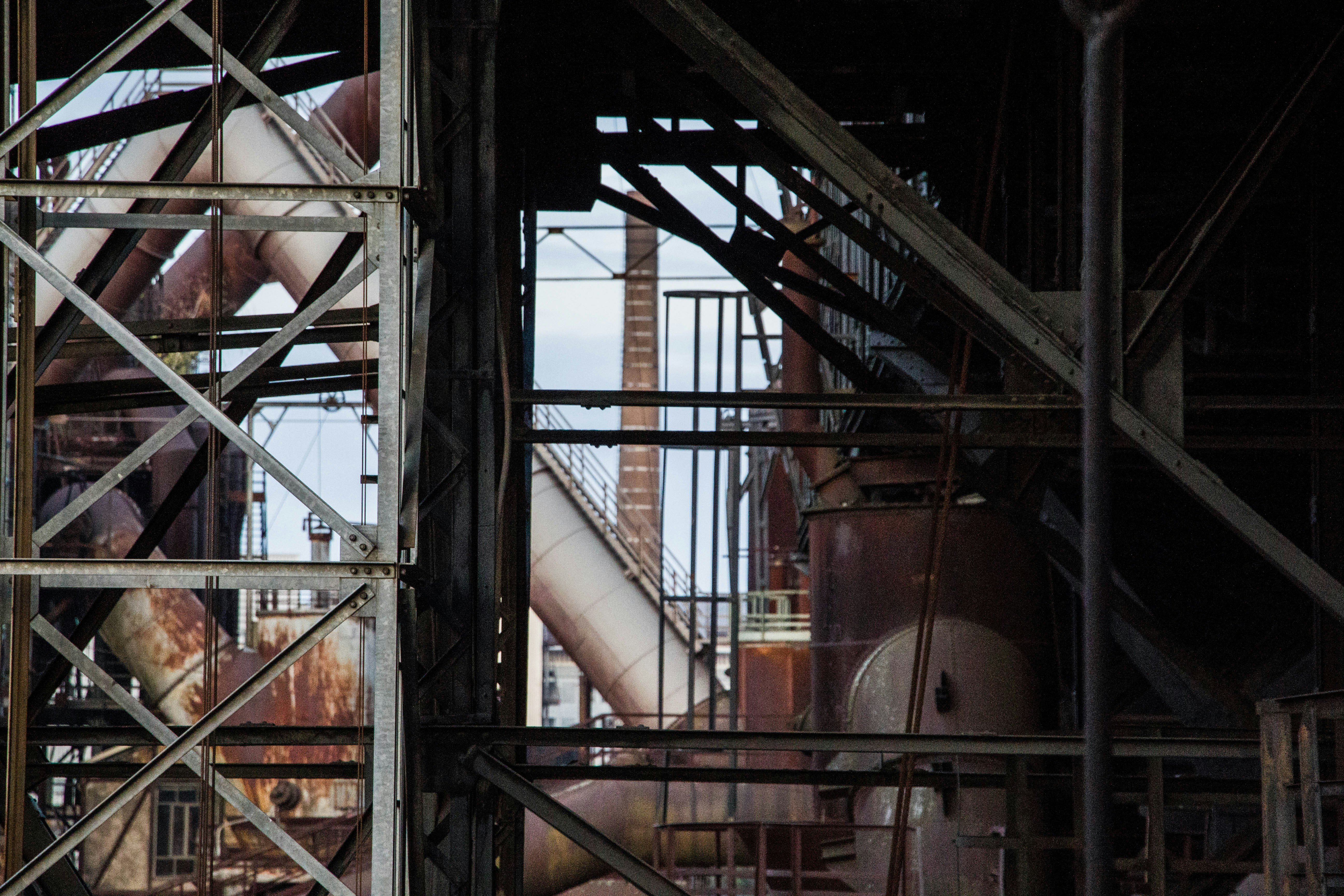 a large metal structure with a clock on top of it
