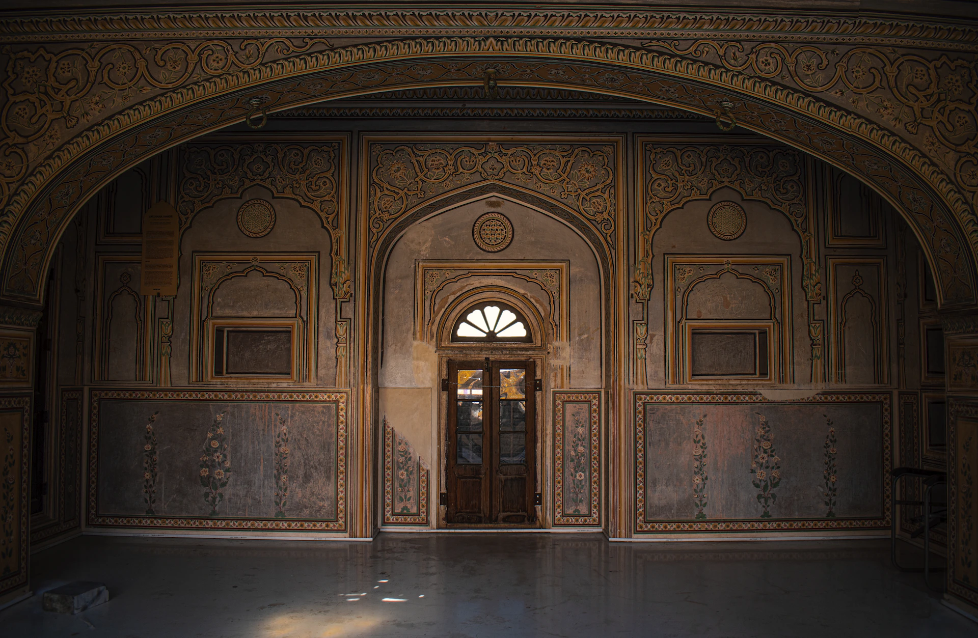 a doorway in a building with a clock on the wall