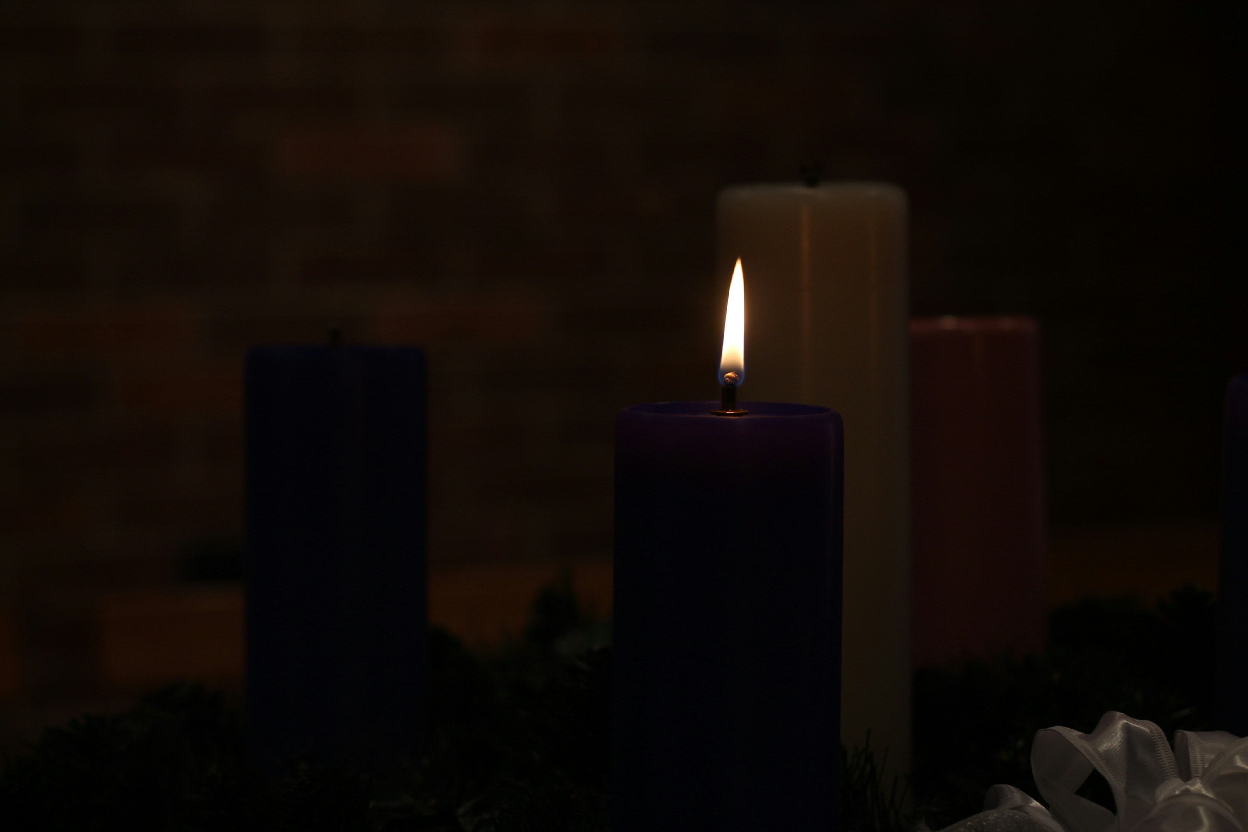a group of lit candles sitting next to each other
