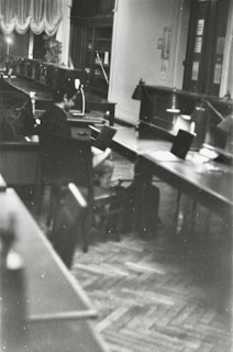 Black and white photo of university students studying together in a library.
