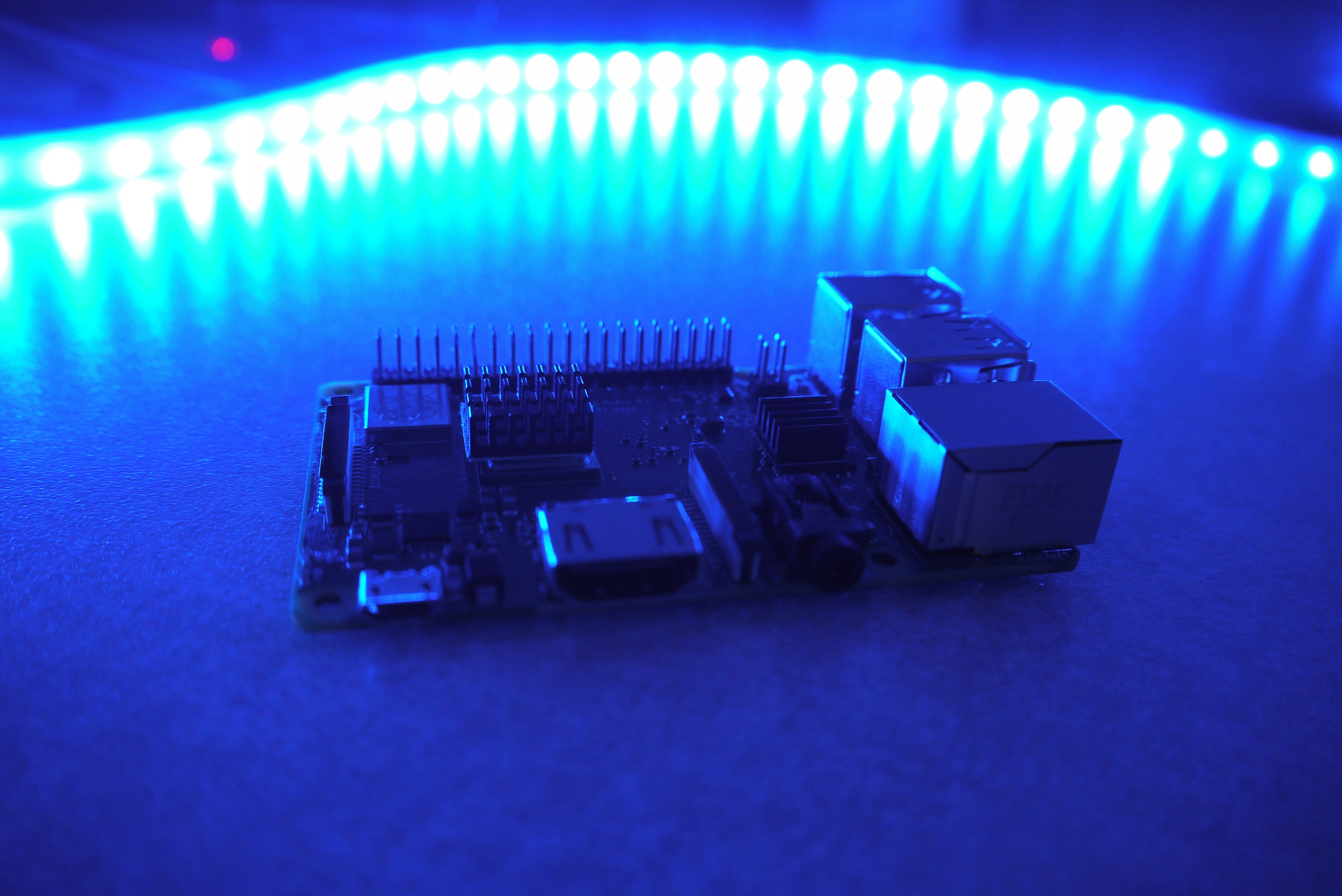 Close-up of a circuit board with glowing blue LED lights in a technology research environment