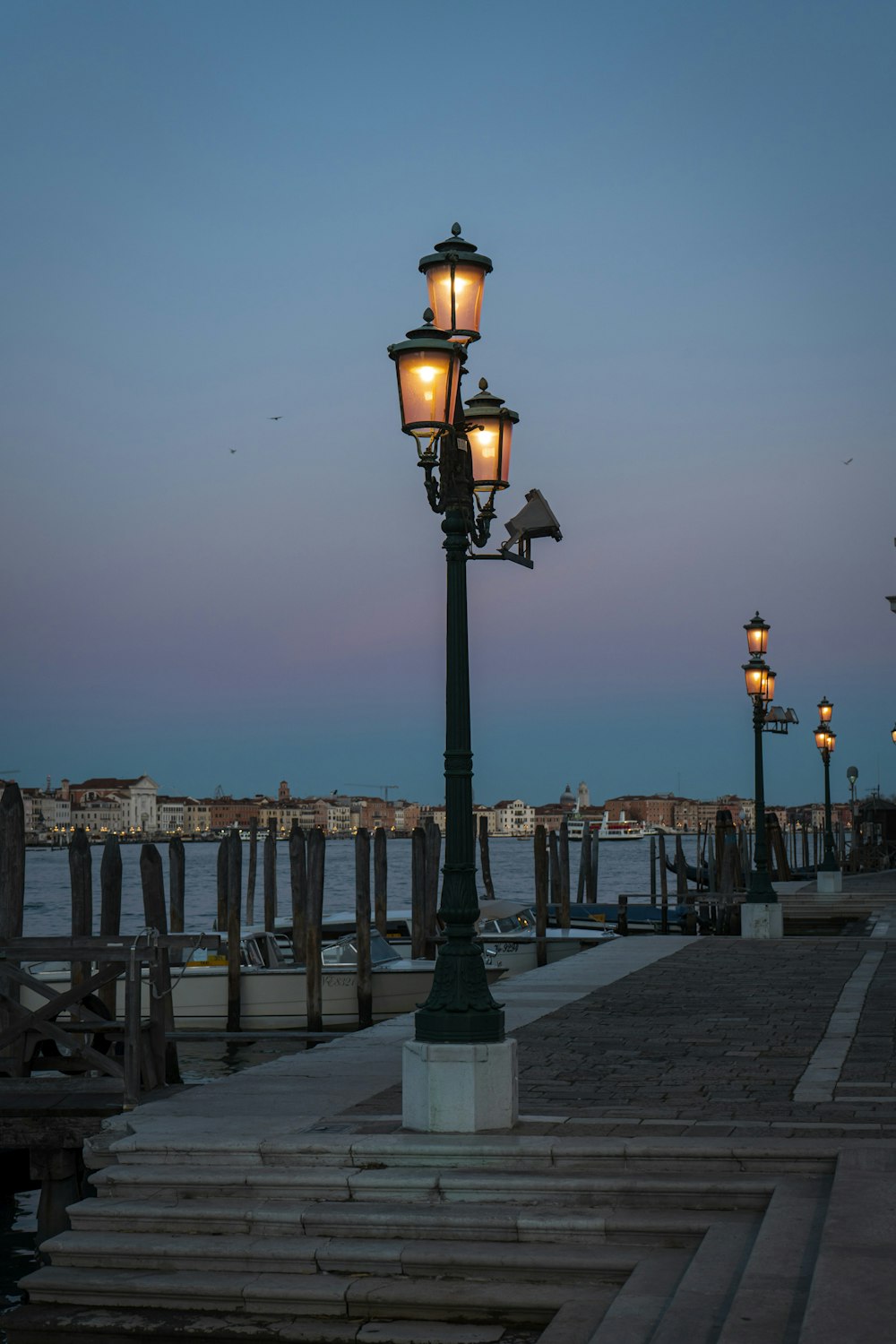 a street light sitting on the side of a pier