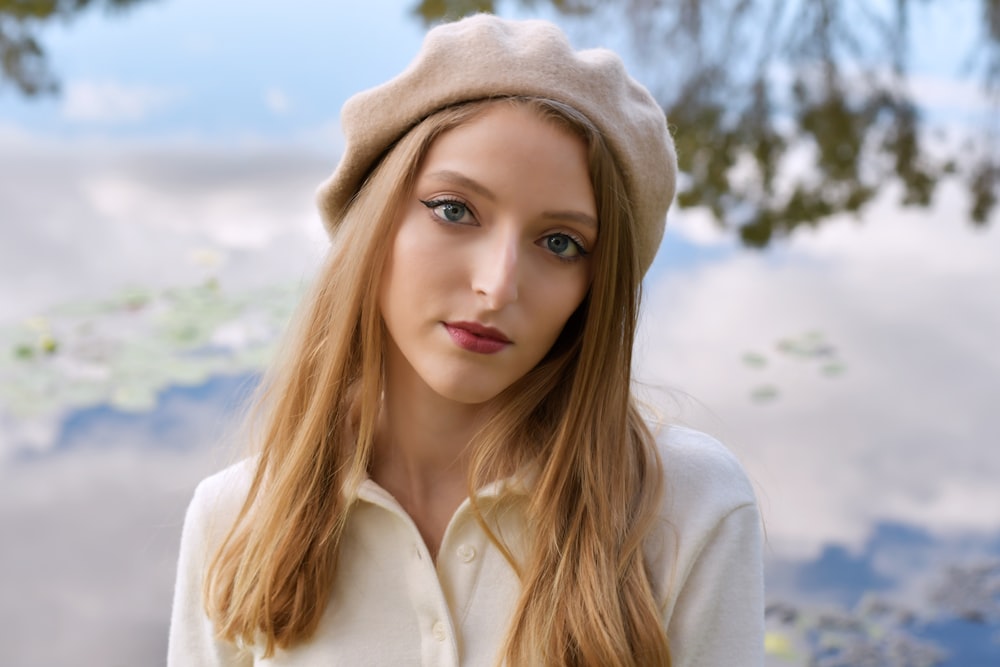 a woman with long hair wearing a hat