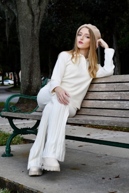 photography poses for women,how to photograph a girl on a bench in all white; a woman sitting on a bench in a park