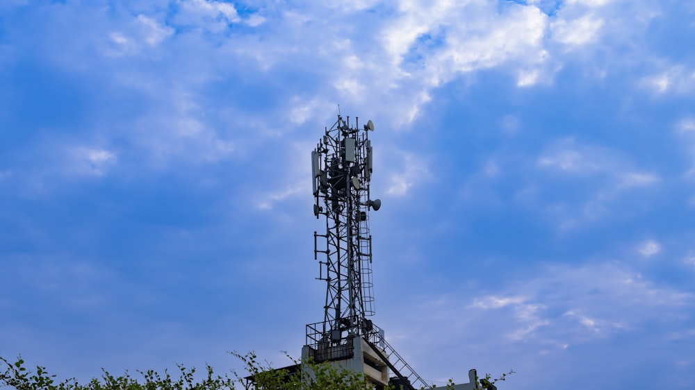 a tower with a cell phone on top of it