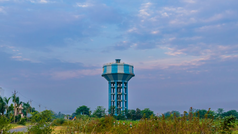 a water tower in the middle of a field