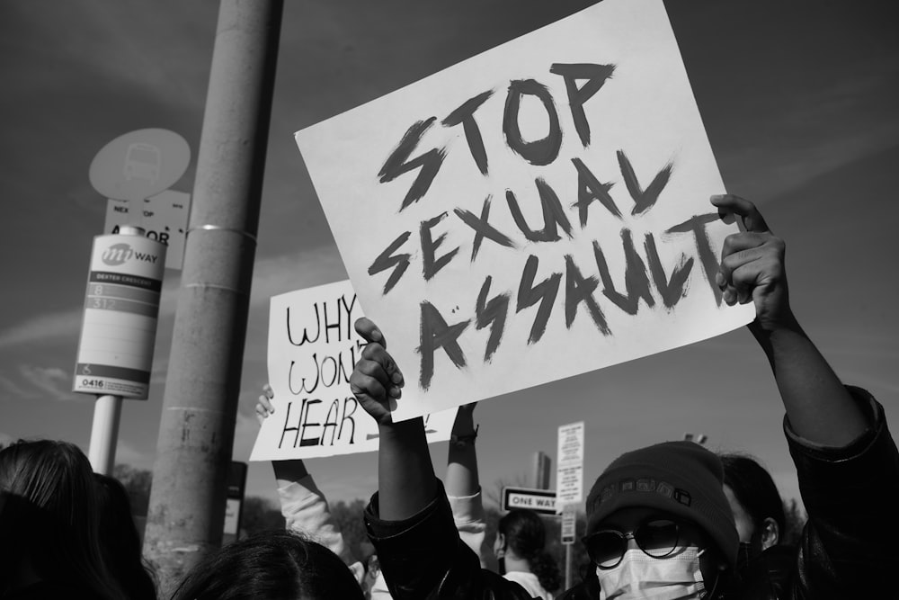 a group of people holding up signs in the air