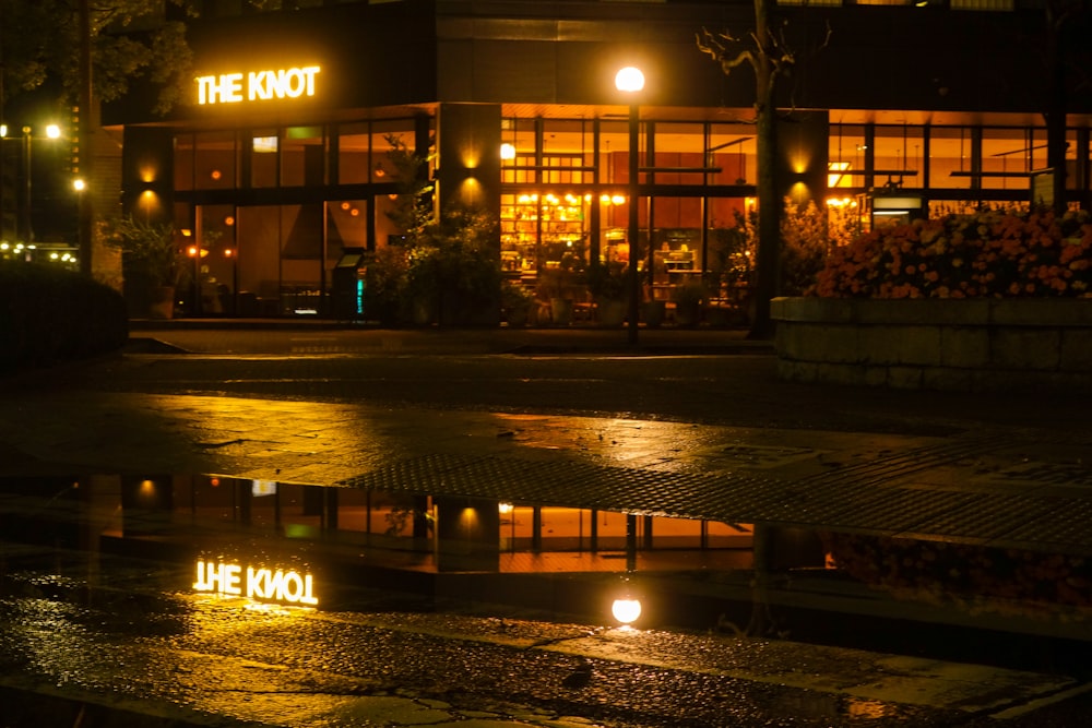 a building with a lit up sign in the rain