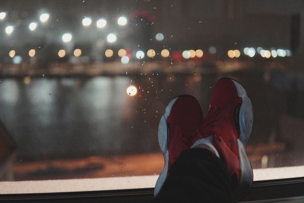 a person's feet sticking out of a window at night
