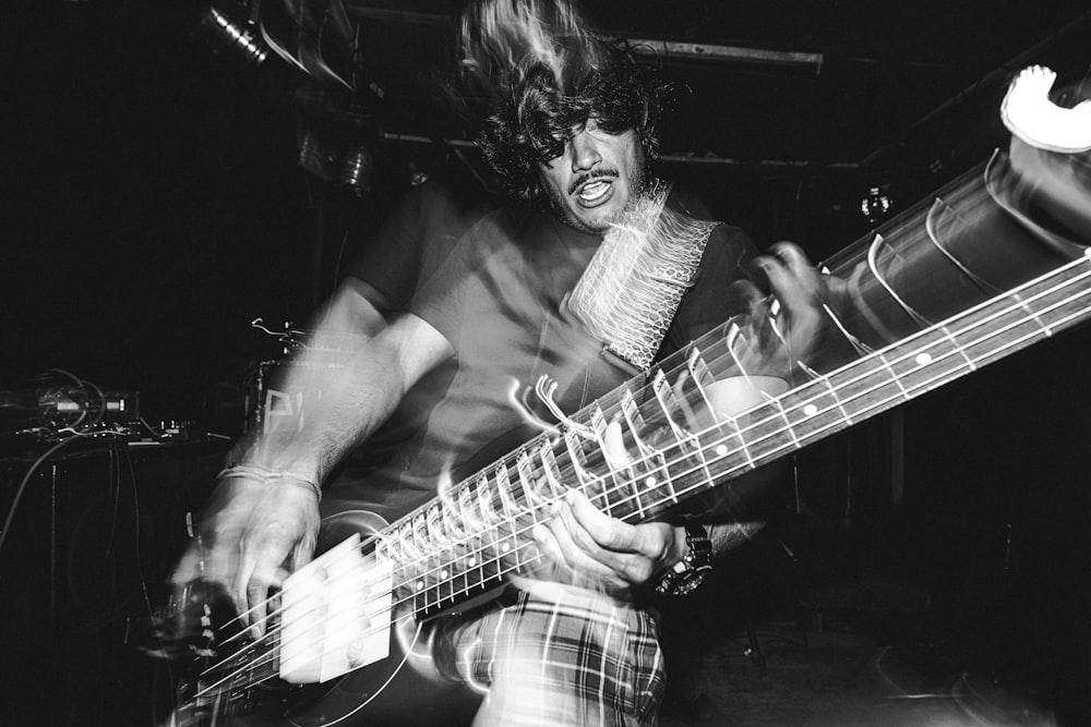 a man that is playing a guitar on a stage