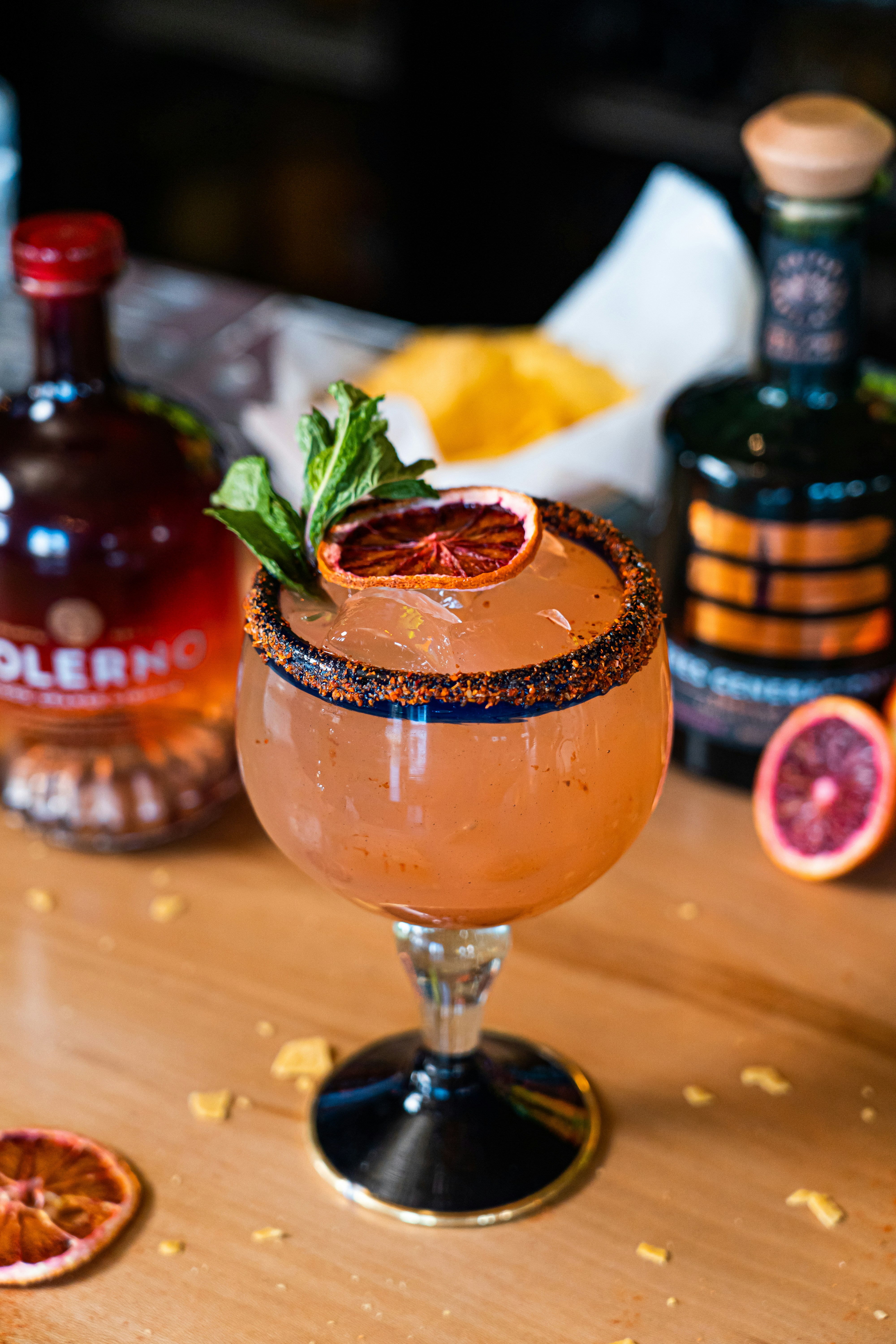 a table topped with a glass filled with a drink