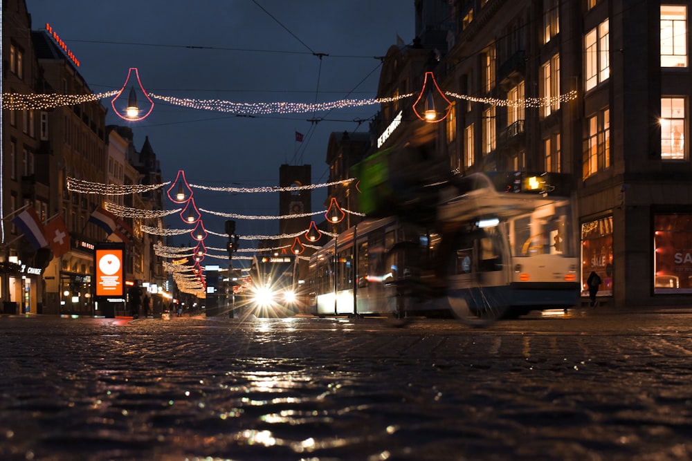 a city street is lit up with christmas lights