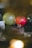 A chocolate cake adorned with a number '30' candle sits on a wooden board. Surrounding it are balloons in various colors including yellow, red, and transparent. A greeting card is partially visible on the left side.