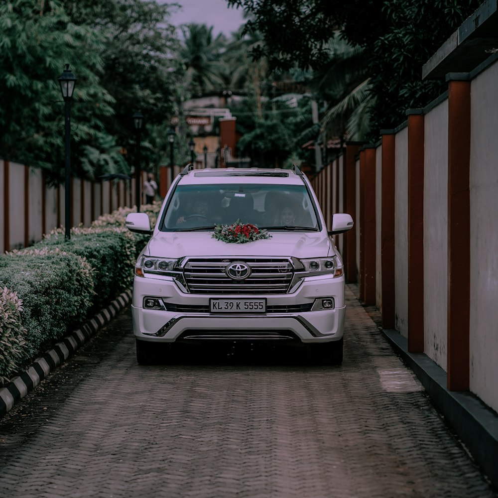 a white suv parked on the side of a road