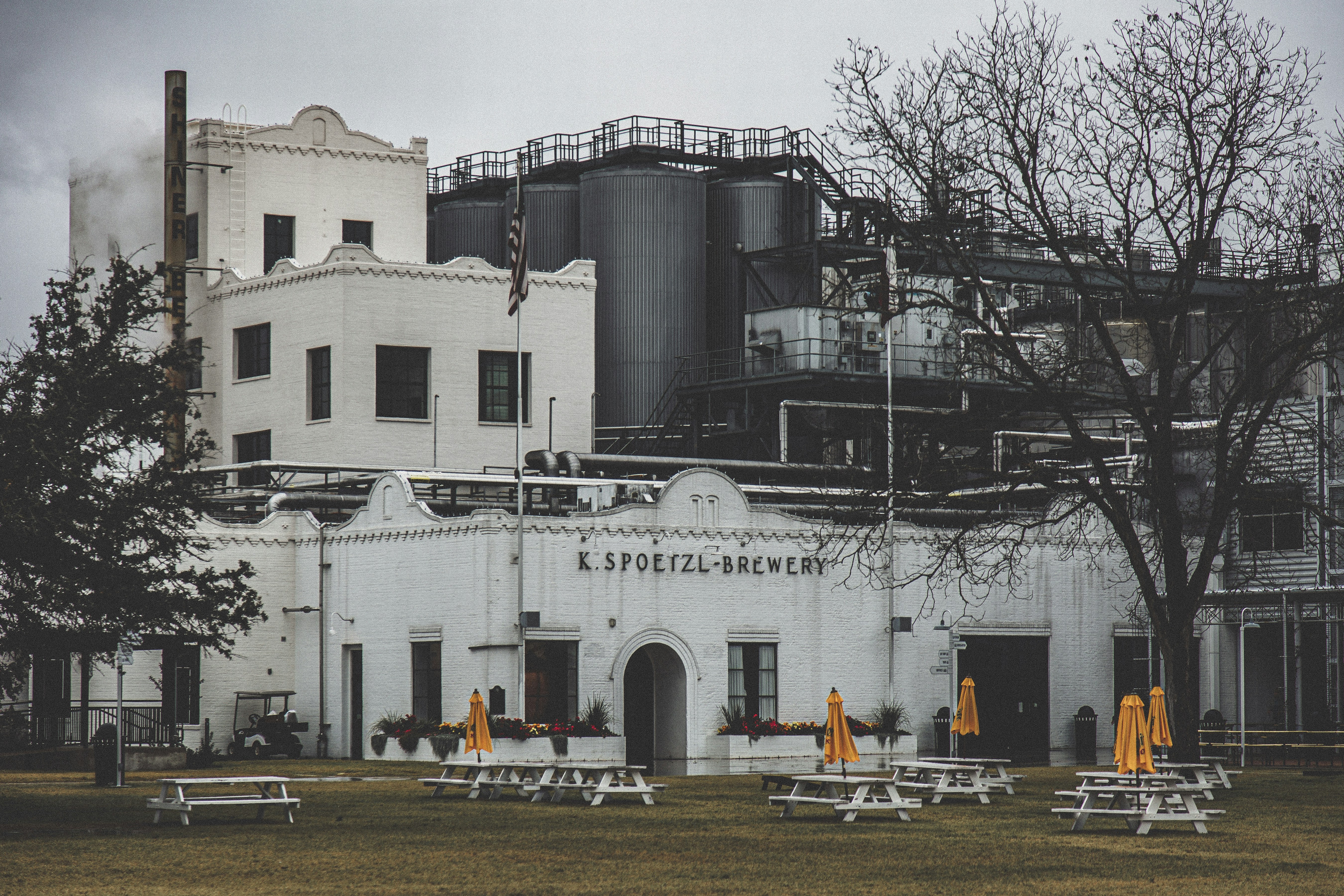 a white building with yellow umbrellas in front of it