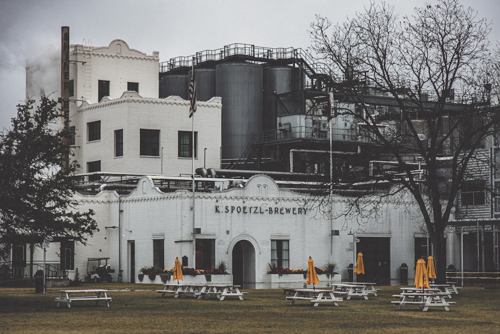 a white building with yellow umbrellas in front of it