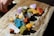 A beautifully arranged collection of colorful gemstone pieces on a rustic wooden table.