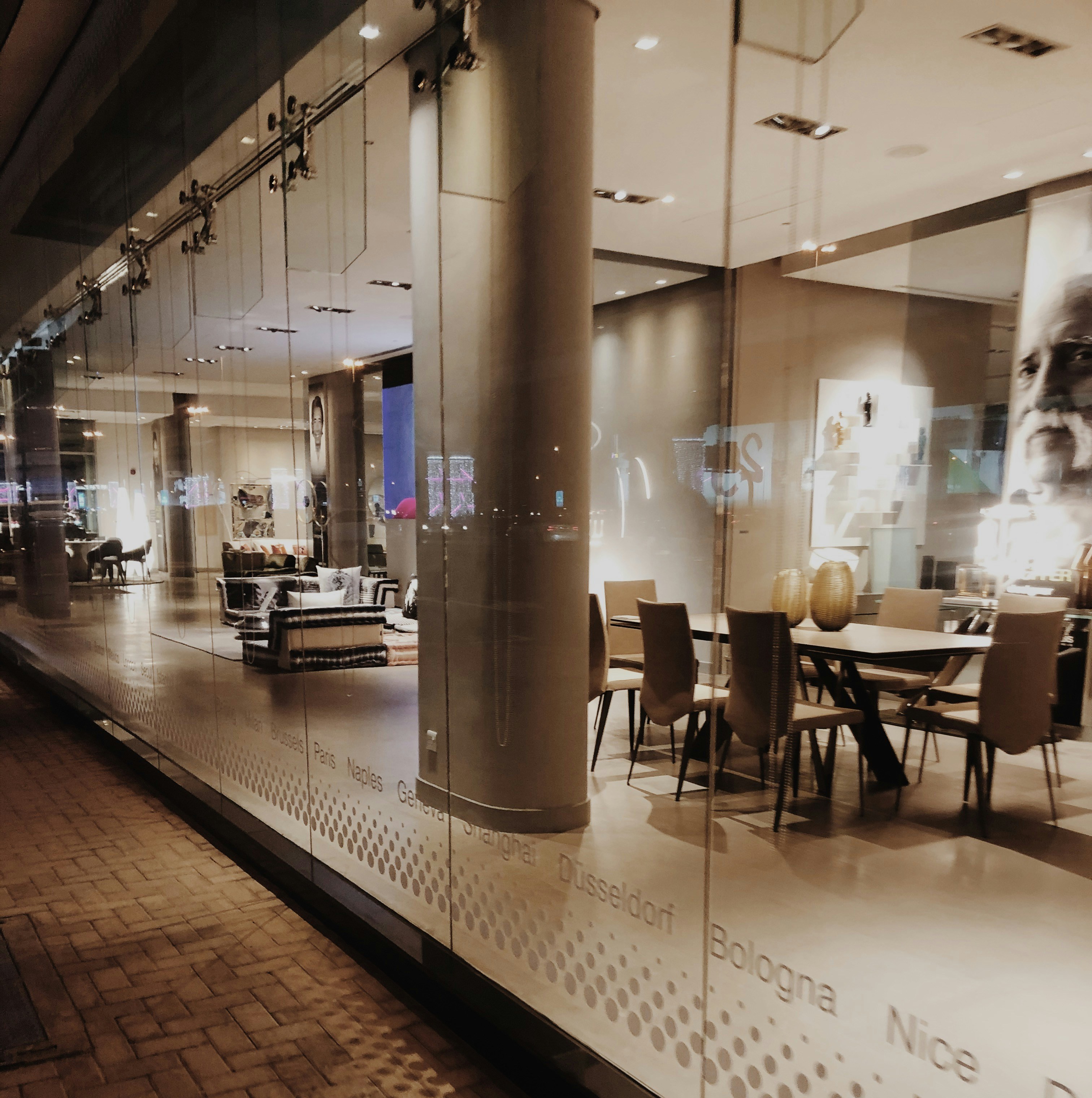 Modern interior furniture in moody dimly lit showroom with dark architectural walls