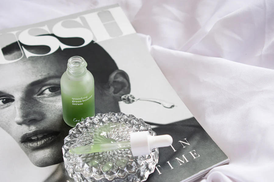 a magazine with a bottle of green liquid next to it